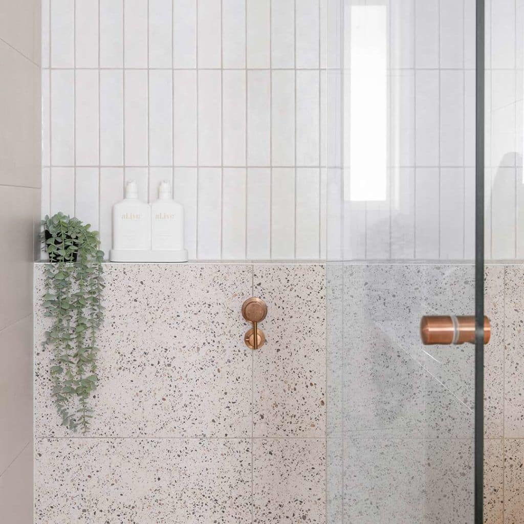 shower with terrazzo and white wall tiles