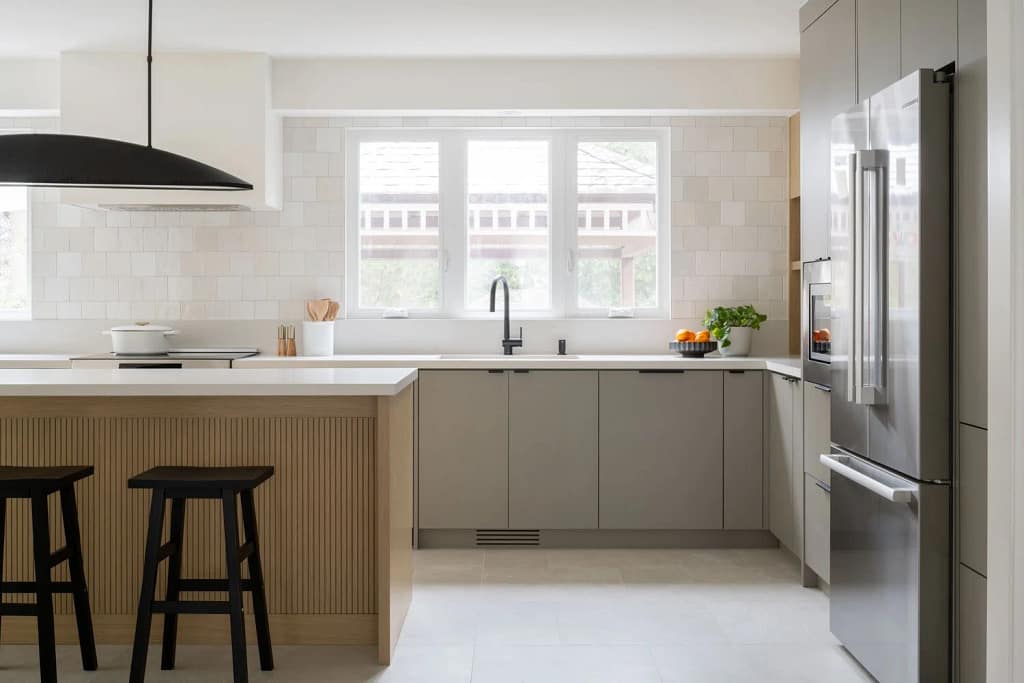Modern kitchen renovation in Richmond featuring grey minimalist cabinetry and a fluted wood island by a professional Richmond kitchen renovation contractor.