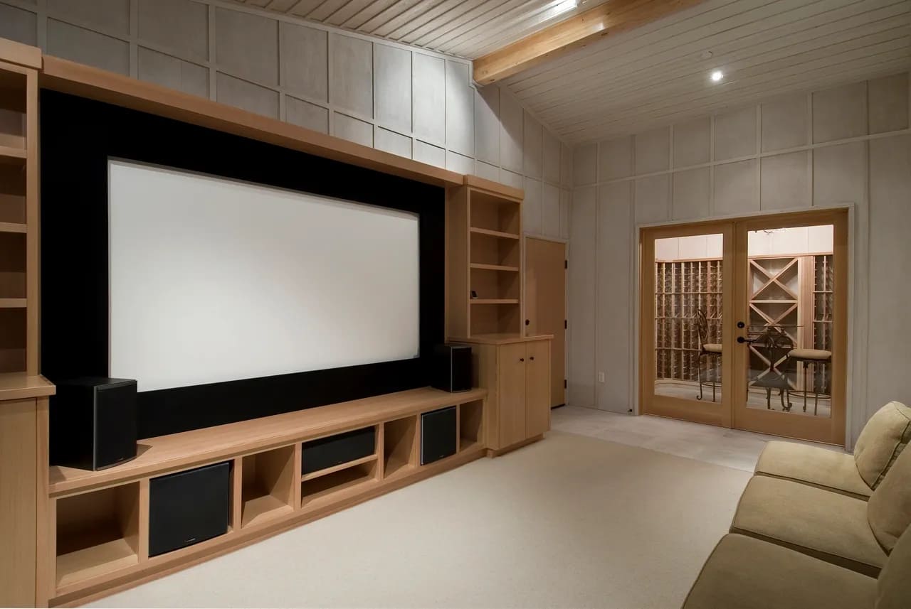 home theater with custom oak millwork and large projector