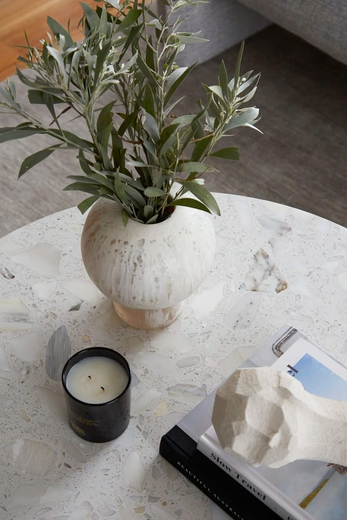 Luxury kitchen renovation in West Vancouver by Quay Construction featuring white shaker cabinets, gold hardware, and a marble-patterned backsplash.