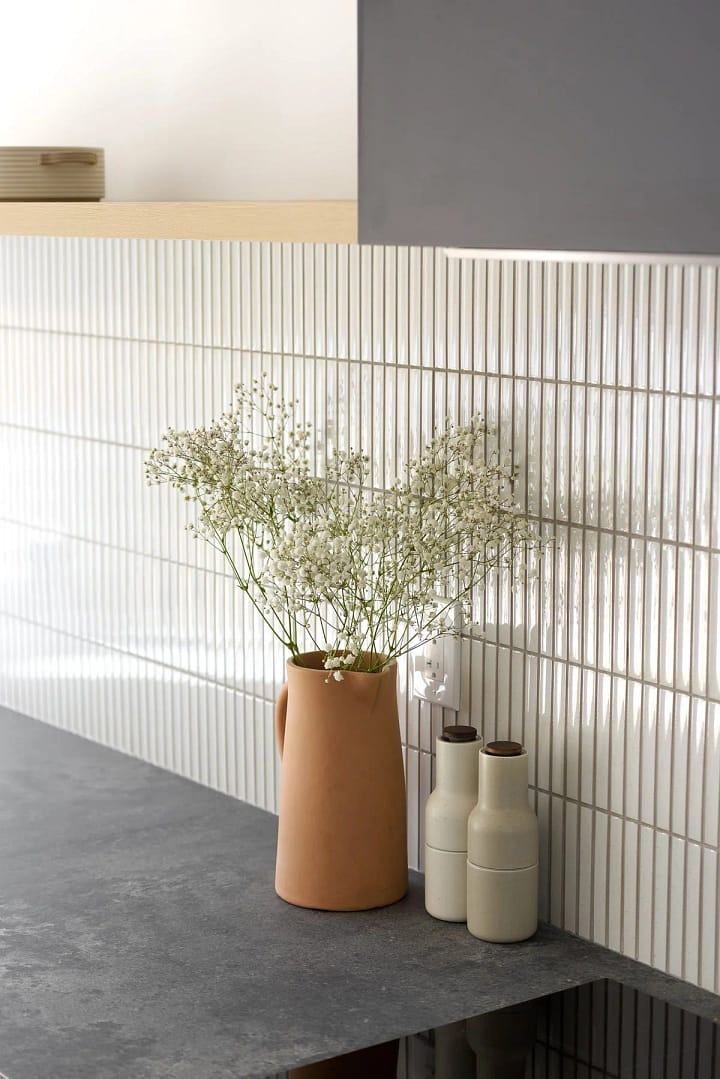 Before and after of a Burke Mountain kitchen renovation, featuring custom cabinetry, quartz countertops, and open-concept layout.
