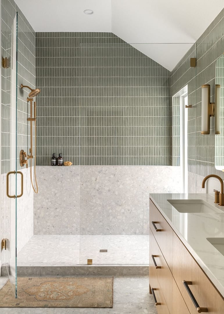 Luxury master bathroom renovation in Lougheed by Quay Construction featuring sage green kit-kat wall tiles, terrazzo flooring, and a floating wood vanity with gold hardware.