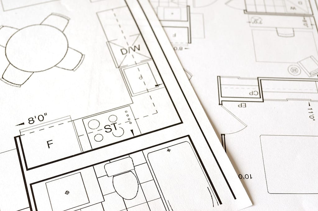 Kitchen renovation planning documents and blueprints on table