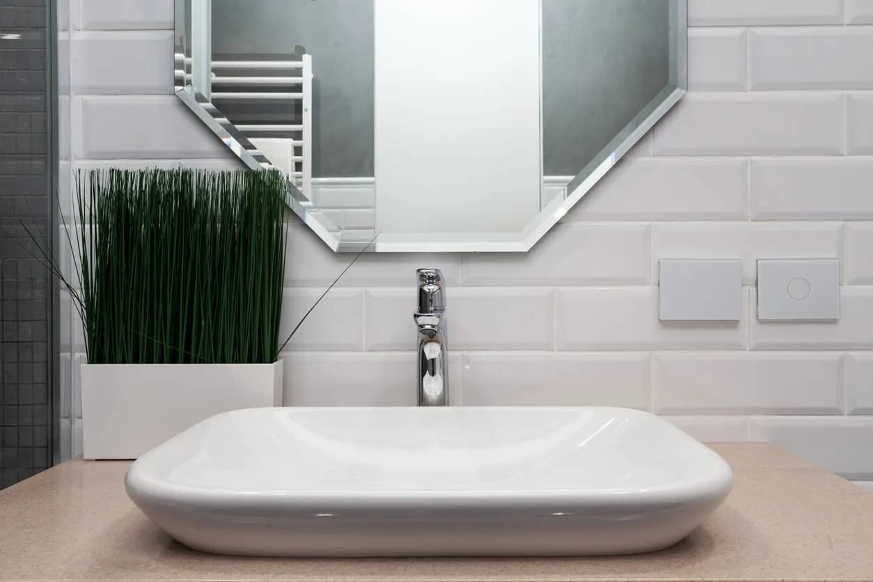 bathroom vanity with vessel sink and white tiles