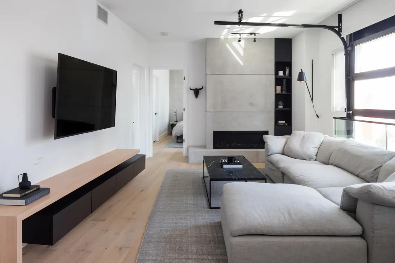 Condo Renovation Vancouver fireplace with concrete surround and custom media wall