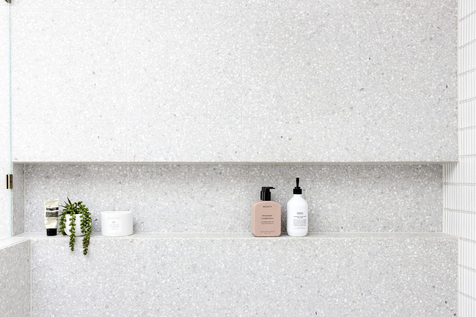 Modern bathroom renovation in Capitol Hill by Quay Construction featuring an infinity niche with large terrazzo tiles.