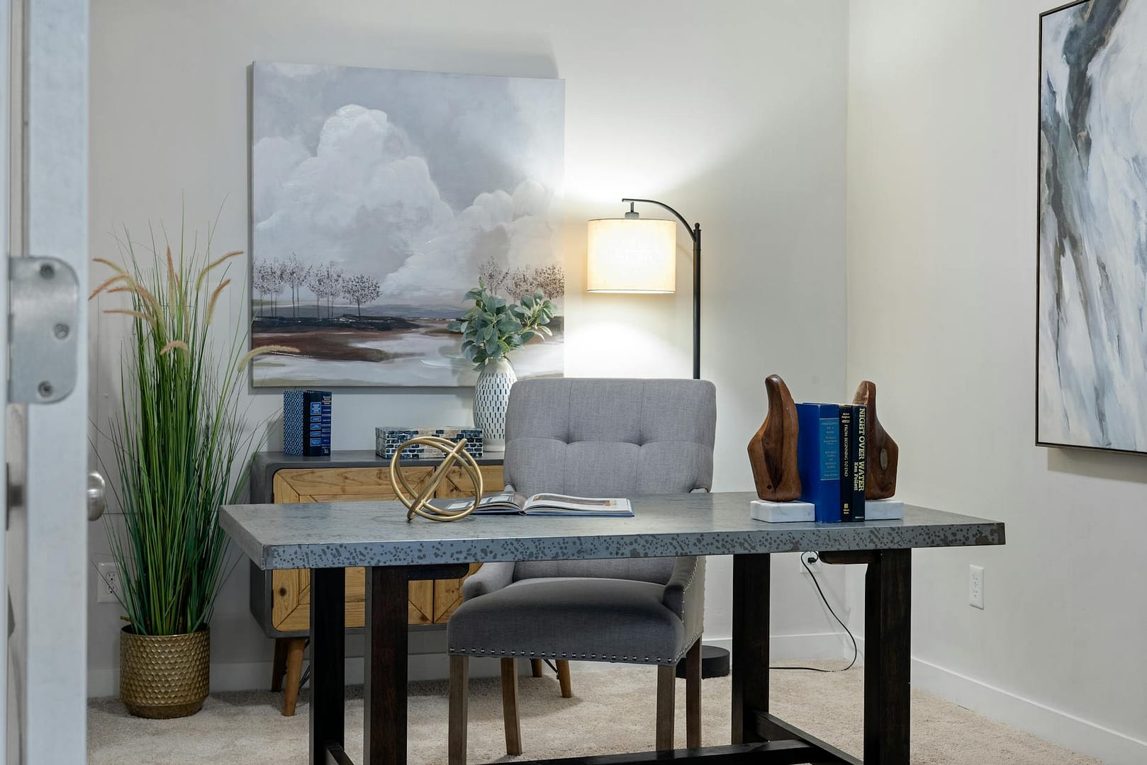 Home office with marble desk and art work