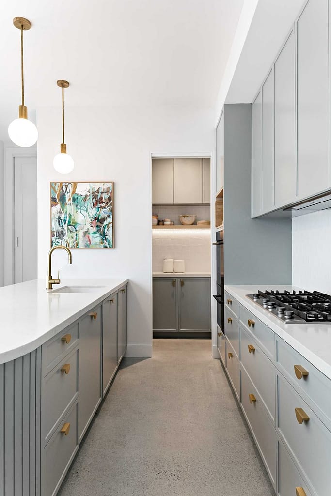 Gourmet kitchen in Westwood Plateau with large island and butler pantry by QUAY Construction