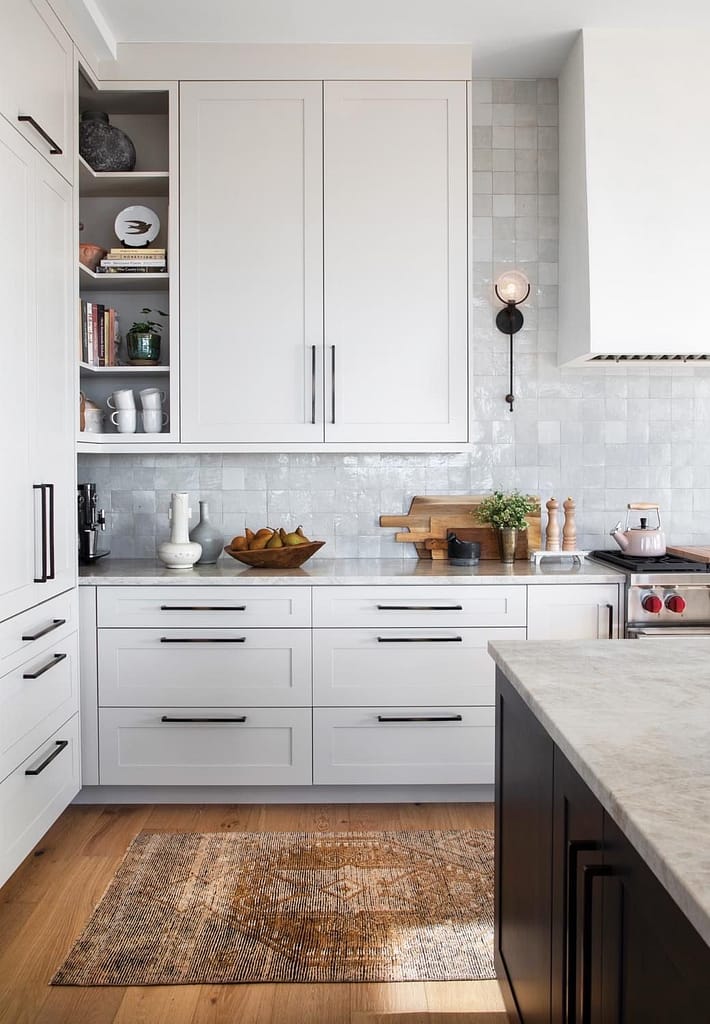 Modern kitchen renovation in Coquitlam featuring white shaker cabinets, grey quartz countertops, stainless appliances, and pendant lighting by QUAY Construction