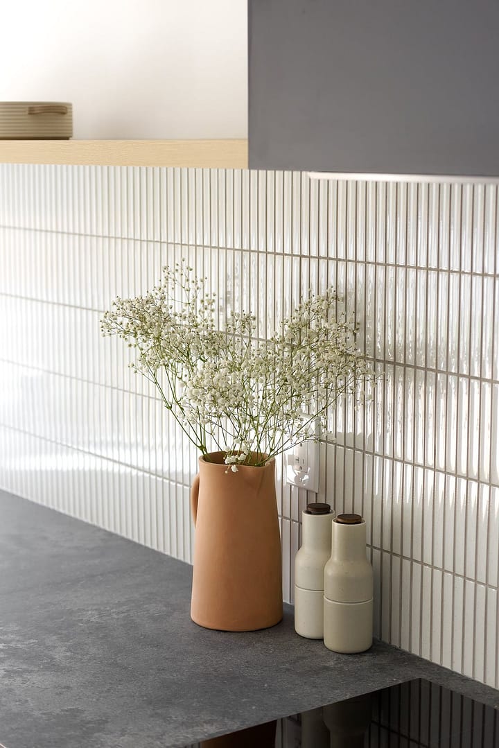 Before and after of a Burke Mountain kitchen renovation, featuring custom cabinetry, quartz countertops, and open-concept layout.
