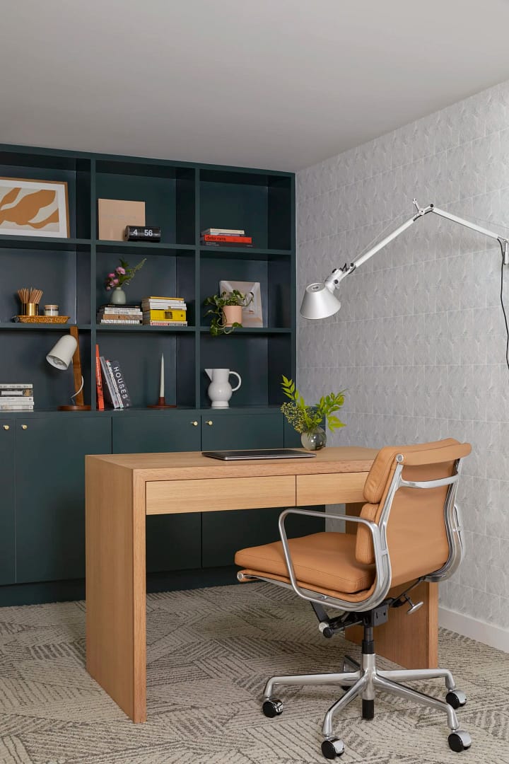 Modern home office featuring a light oak desk and tan leather chair from a professional basement renovation in Burnaby by QUAY Construction.