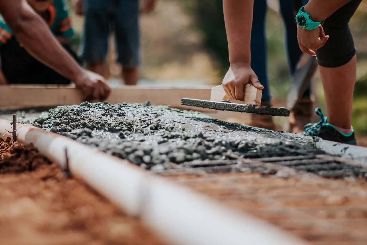 People building a foundation for a house.