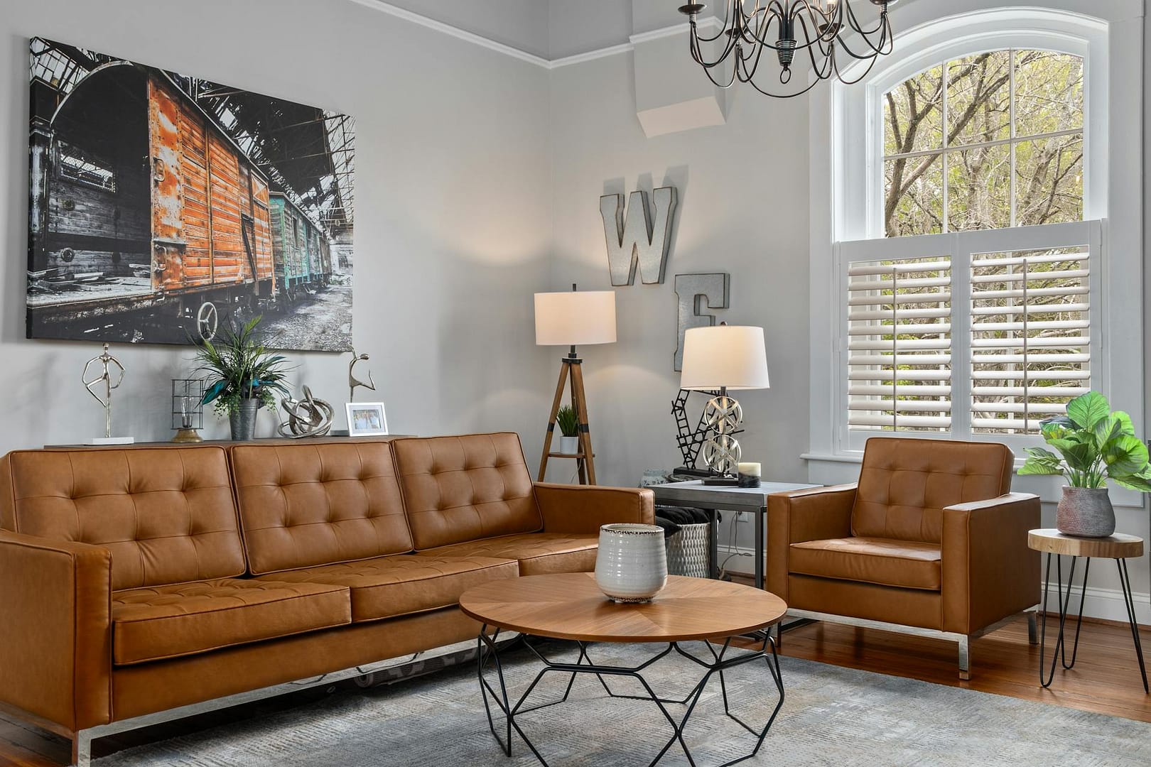 condo living room with brown couches and modern decor