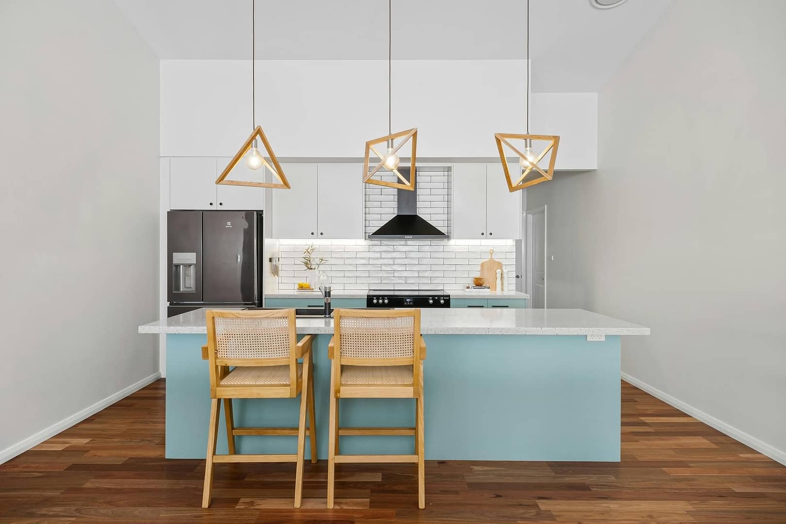 kitchen with green island and triangle pendants