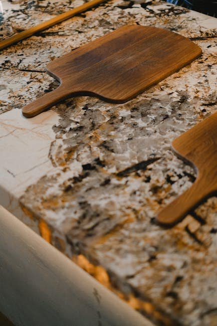 Stylish wooden paddle trays on a sophisticated marble countertop. Ideal kitchen decor.