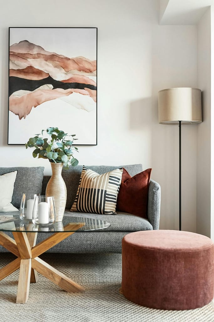 living room with fabric couch and glass coffee table
