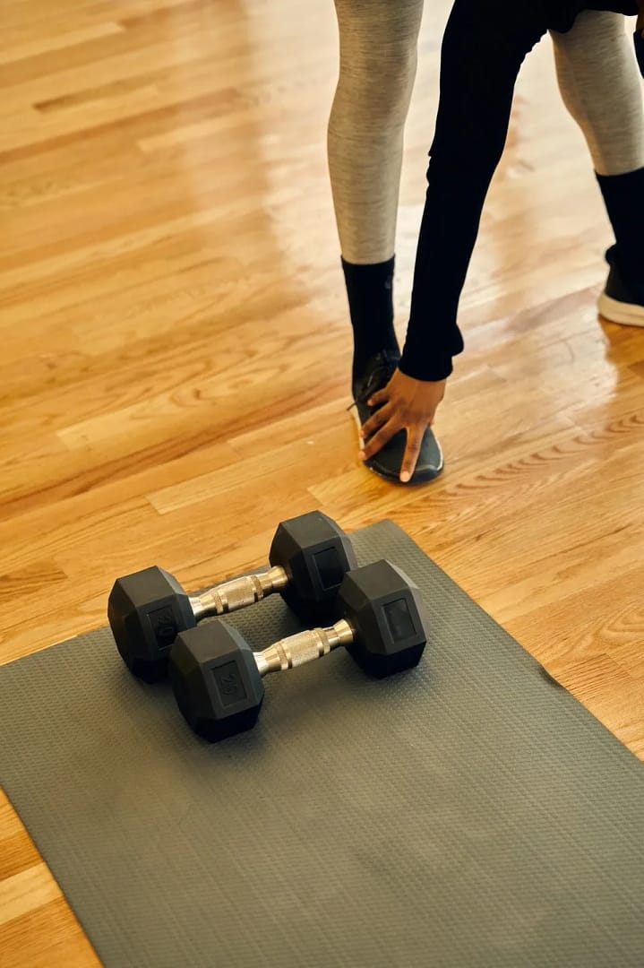 Yoga mat with weights, person stretching