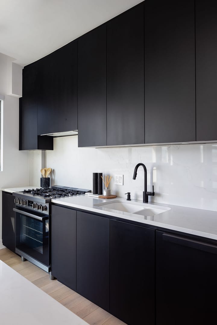 custom kitchen with black cabinets and white countertops