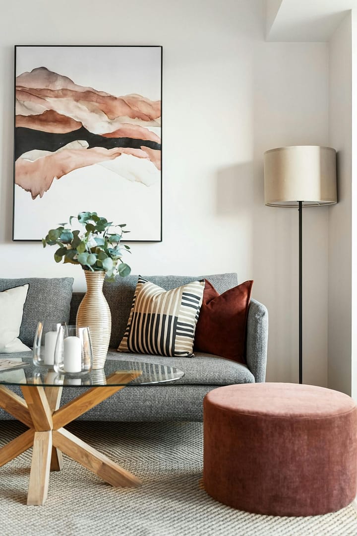 living room with fabric couch and glass coffee table